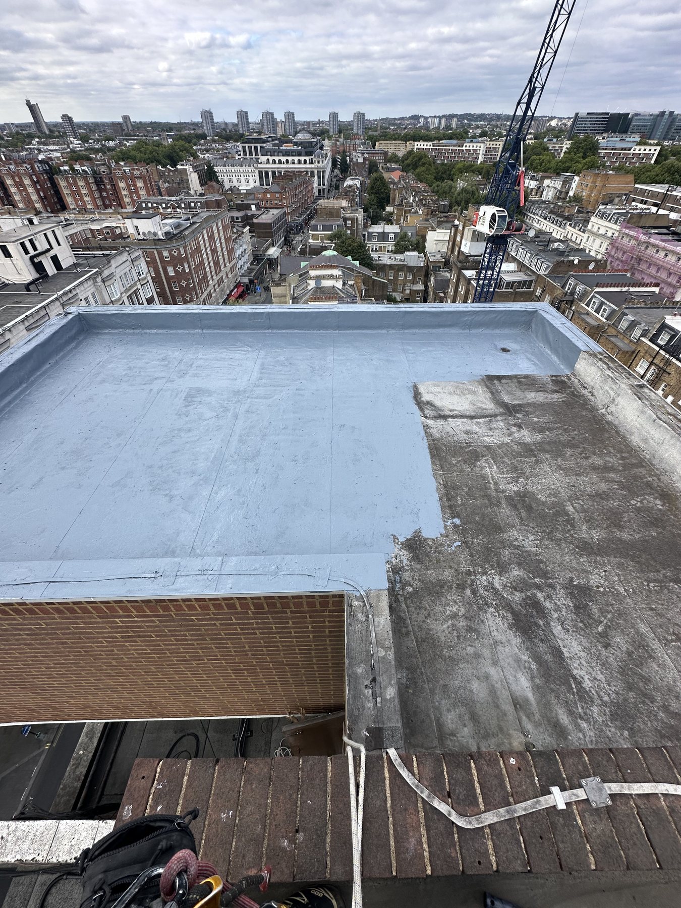Commercial roof maintenance in London before localised flat roof repair by Ropeguys