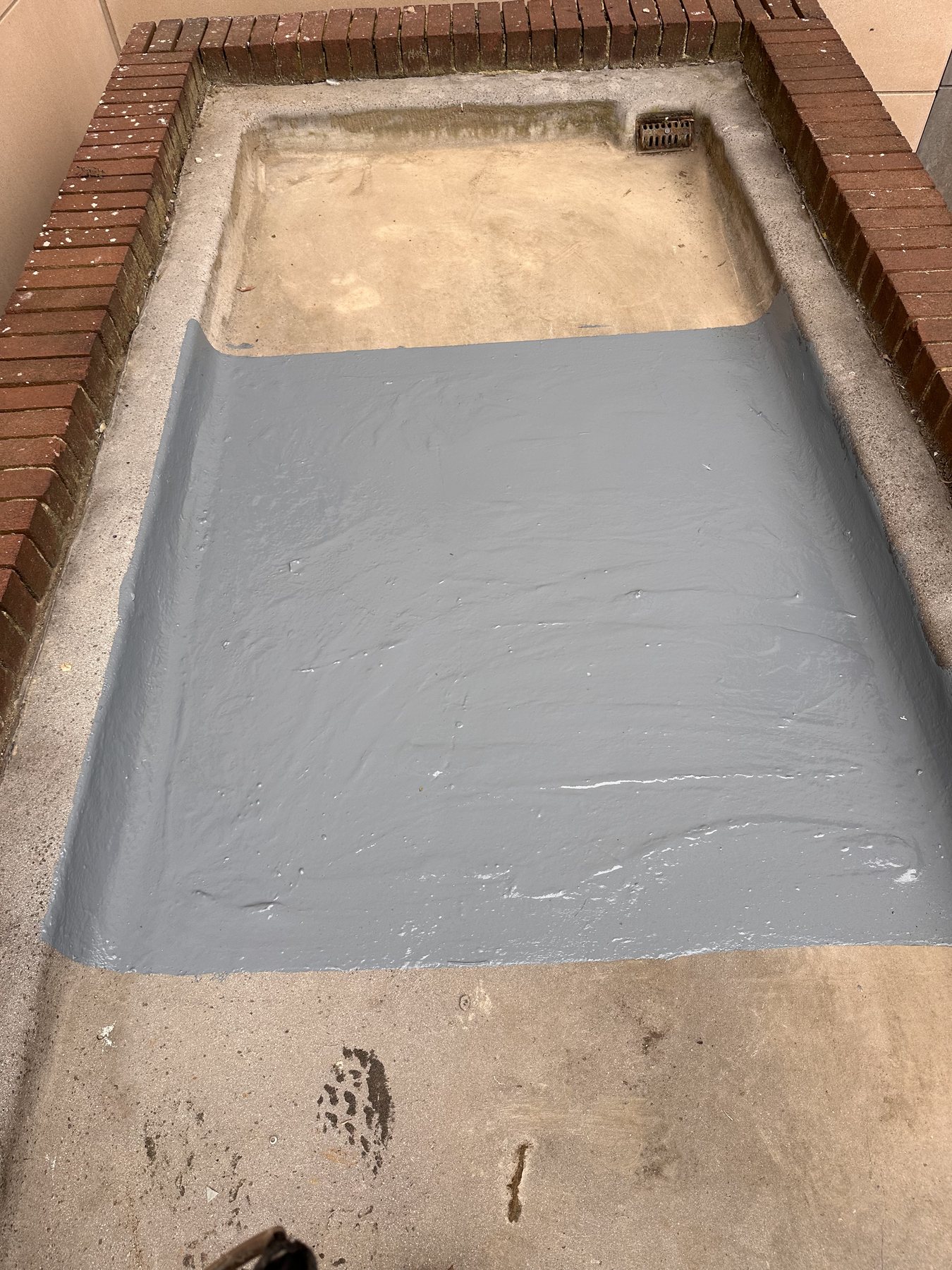 Emergency flat roof repair in London with new grey waterproof coating applied by Ropeguys