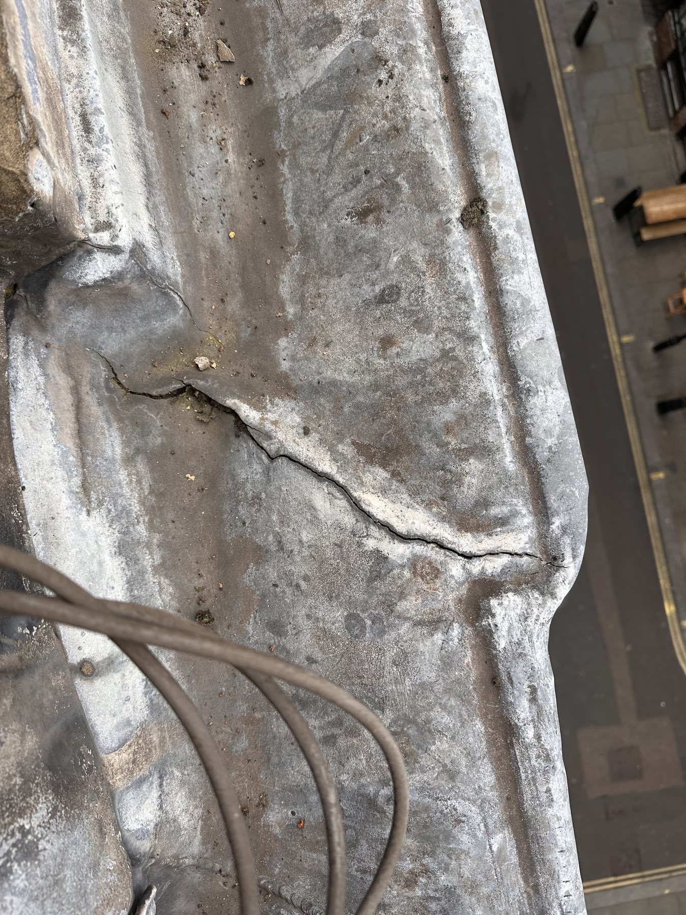 Roof leak investigation in London showing cracked roof detail inspected by Ropeguys