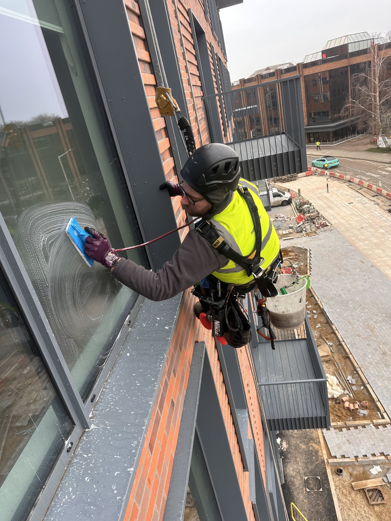 IRATA rope access window cleaning technicians working on commercial glazing