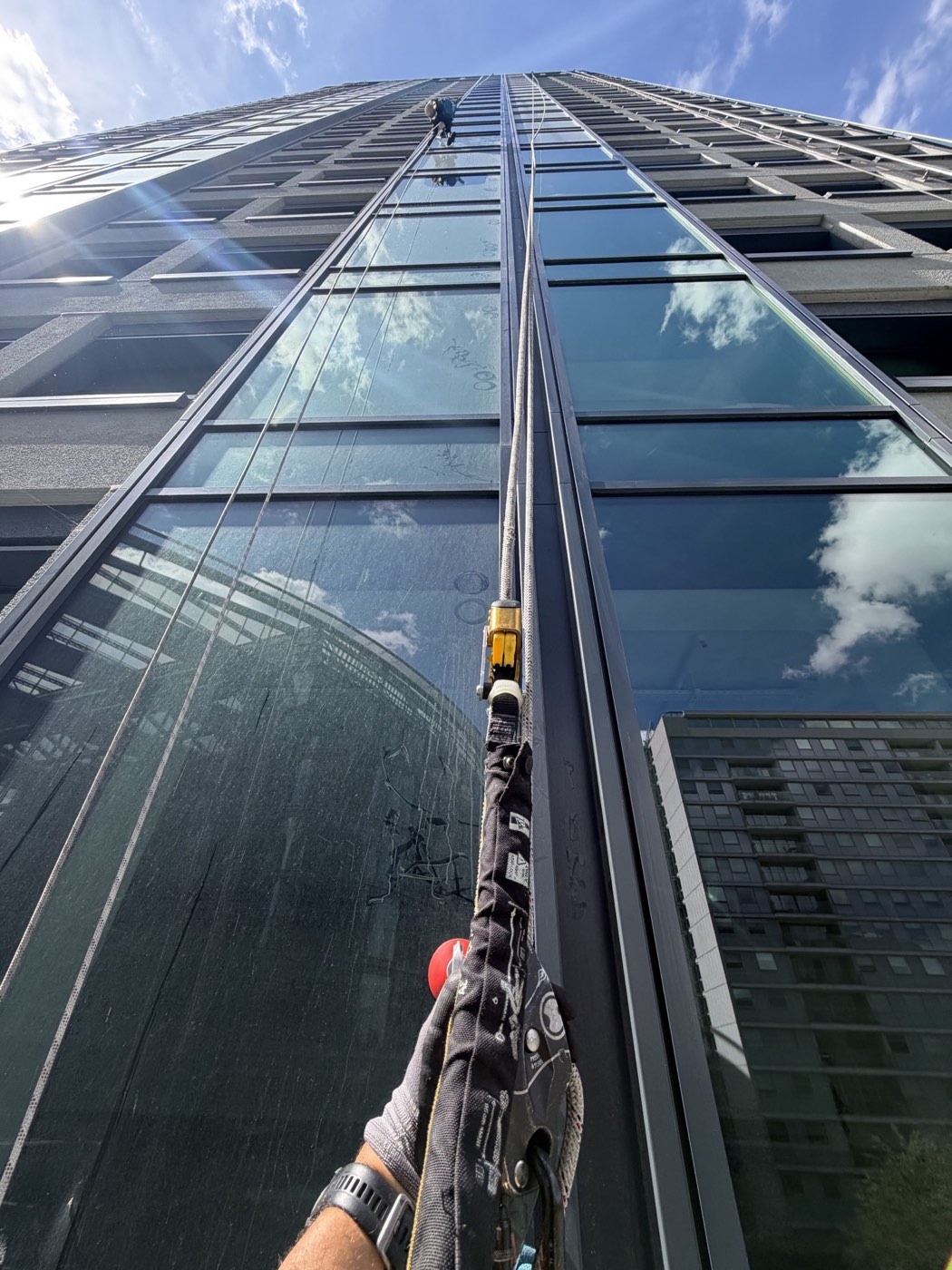 Rope access builders clean in progress on the Thirty High facade in Victoria London
